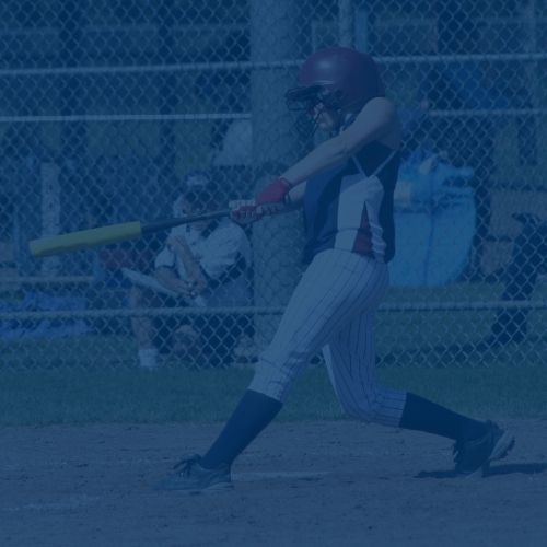softball player swinging at bat during a game
